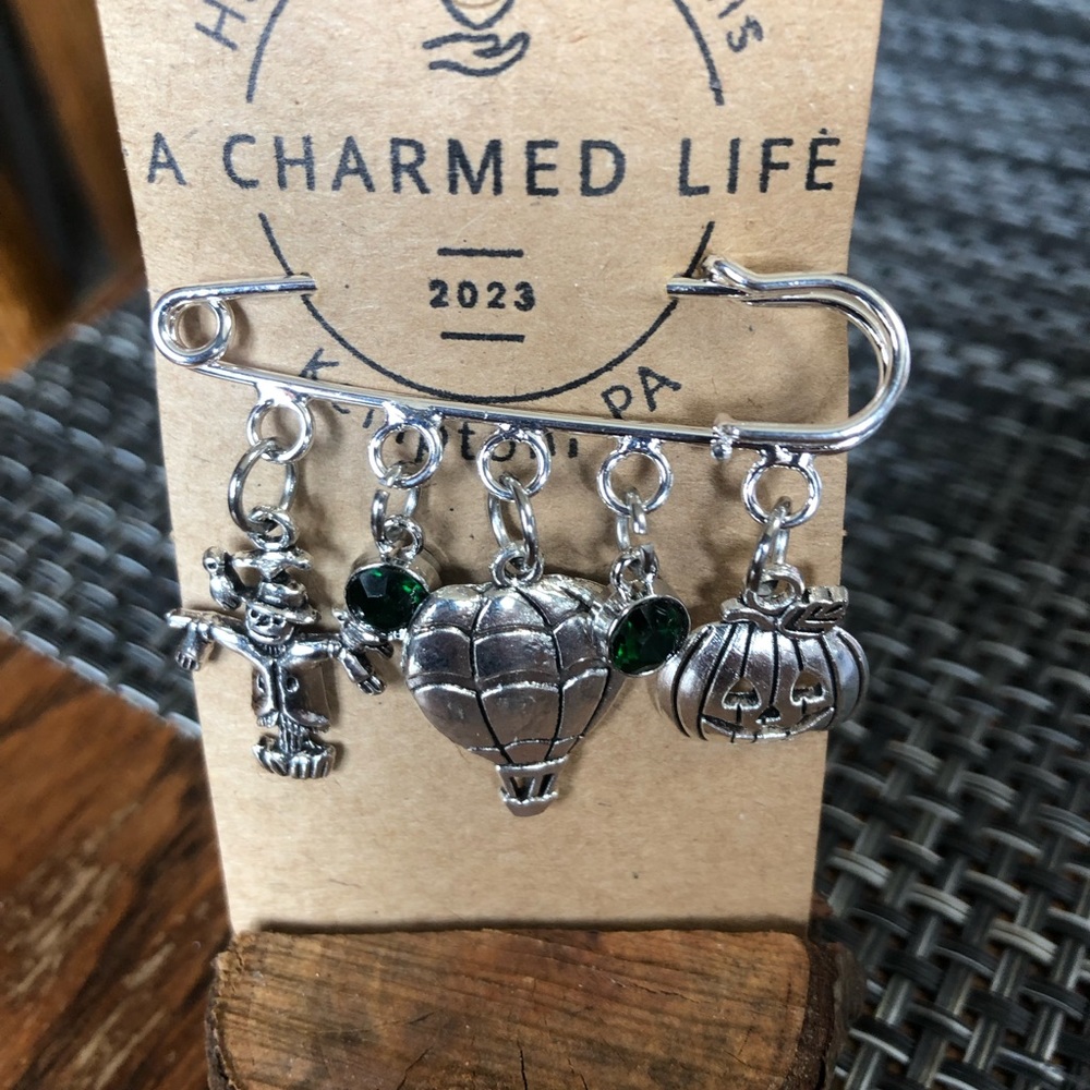 NWT, Handmade by A Charmed Life. Silver 2” Silver Pin with Wizard of Oz Charms